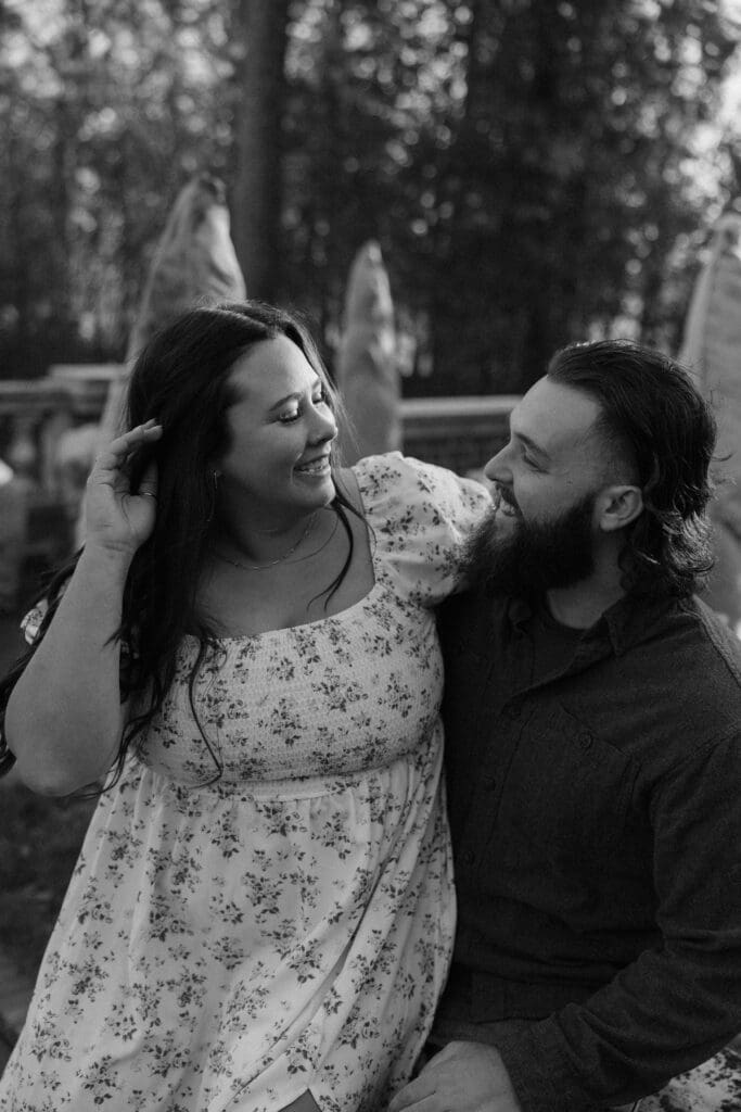 Candid black-and-white engagement photo of a couple laughing together in Duluth, Minnesota.