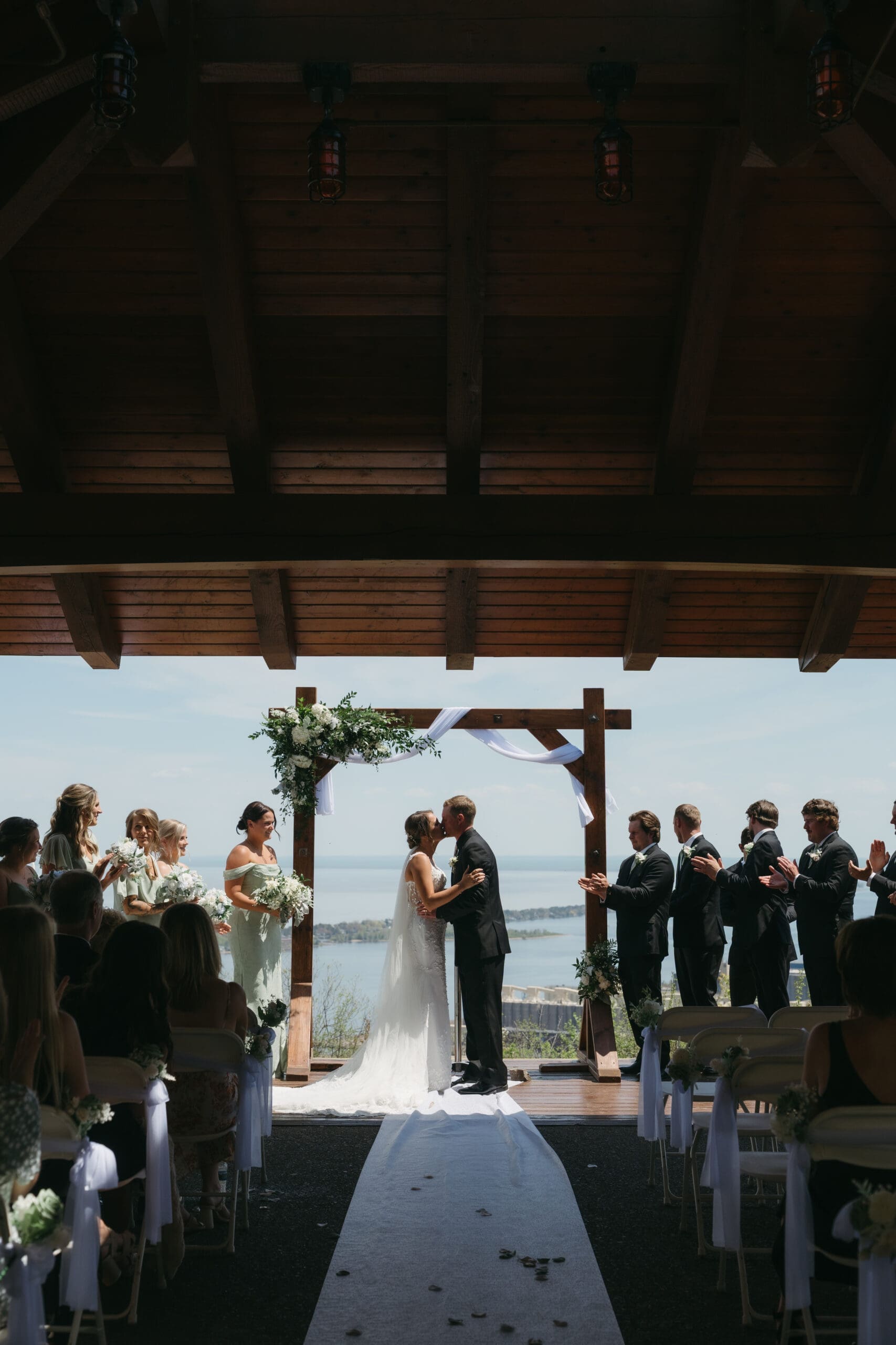 couple kissing at their enger tower wedding